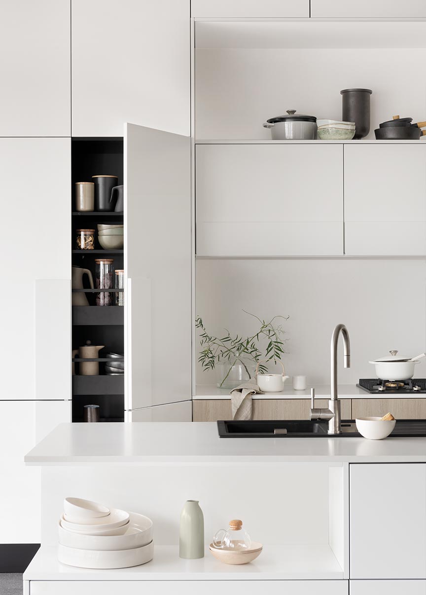 White zen style kitchen featuring Laminex and Essastone